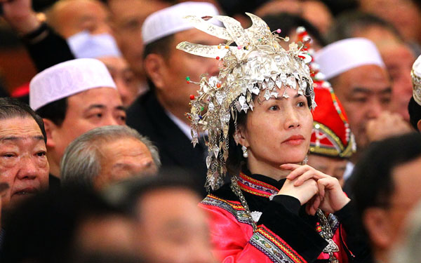 An ethnic group member of the Chinese People&apos;s Political Consultative Conference National Committee listens attentively to the opening speeches in Beijing, March 3, 2011.