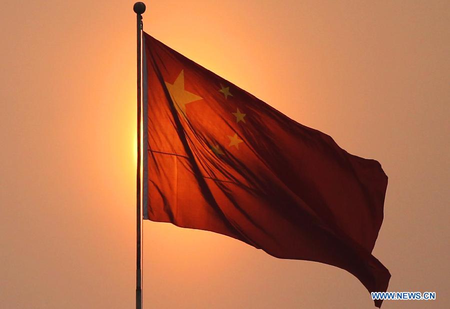 A flag-raising ceremony is held on the Tiananmen Square near the Great Hall of the People in Beijing, capital of China, March 5, 2012. The Fifth Session of the 11th National People's Congress (NPC) will open in Beijing on Monday.