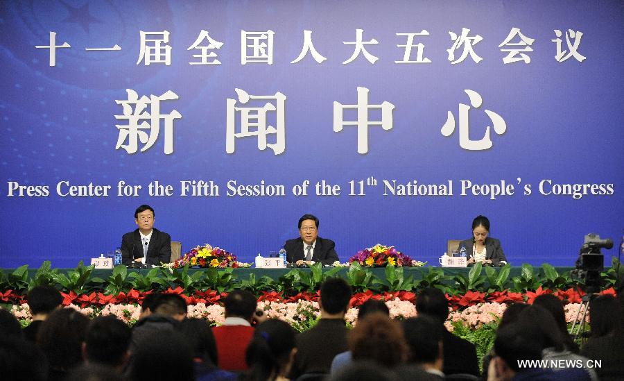 Zhang Ping (C), minister of the National Development and Reform Commission, speaks at a press conference of the Fifth Session of the 11th National People's Congress (NPC) in Beijing, capital of China, March 5, 2012.
