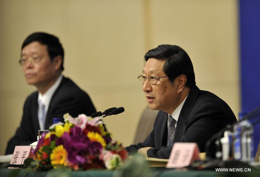 Zhang Ping (R), minister of the National Development and Reform Commission, speaks at a press conference of the Fifth Session of the 11th National People's Congress (NPC) in Beijing, capital of China, March 5, 2012.