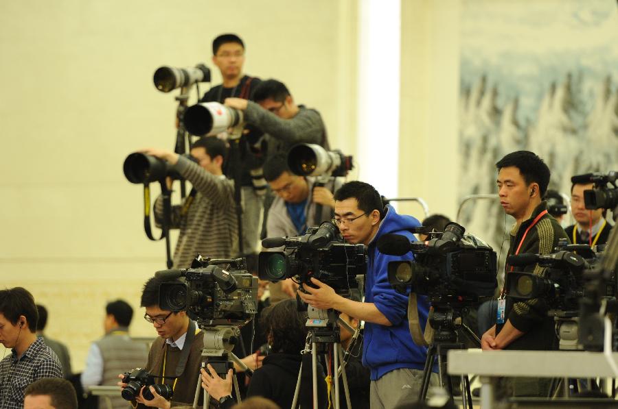 Journalists work during a press conference of Chinese Foreign Minister Yang Jiechi held on the sidelines of the Fifth Session of the 11th National People&apos;s Congress (NPC) at the Great Hall of the People in Beijing, China, March 6, 2012.