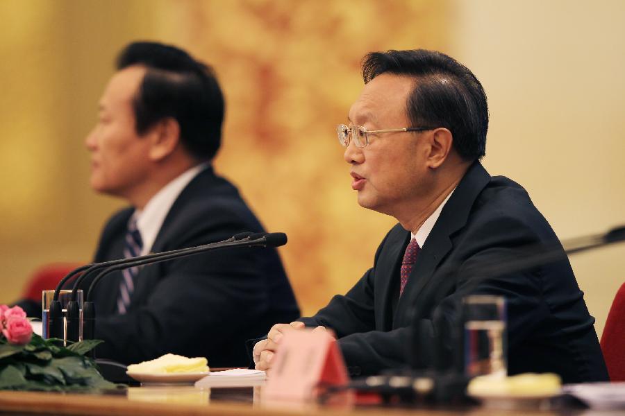 Chinese Foreign Minister Yang Jiechi (R) answers questions during a news conference on the sidelines of the Fifth Session of the 11th National People&apos;s Congress (NPC) at the Great Hall of the People in Beijing, China, March 6, 2012. 