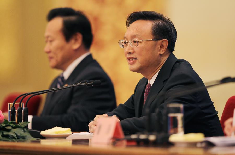 Chinese Foreign Minister Yang Jiechi (R) answers questions during a news conference on the sidelines of the Fifth Session of the 11th National People&apos;s Congress (NPC) at the Great Hall of the People in Beijing, China, March 6, 2012.