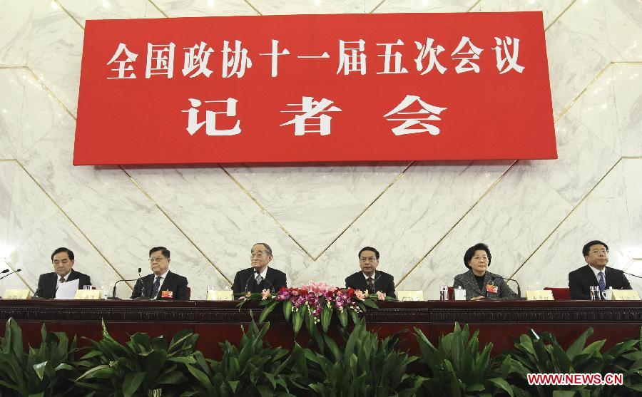 Members of the 11th National Committee of the Chinese People's Political Consultative Conference (CPPCC) Li Yining (3rd L), Chen Xiwen (3rd R), Xu Shanda (2nd L), Ma Xiuhong (2nd R), Yang Kaisheng (1st L) and Ren Hongbin (1st R) attend a press conference in Beijing, capital of China, March 6, 2012.