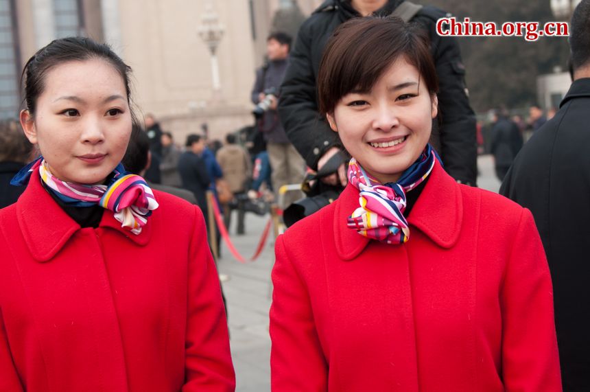 Staff workers from the hotels that host the delegates to the 11th National People&apos;s Congress (NPC) beam at the lens amid the opening ceremony of the the Congress&apos; fifth annual session. [China.org.cn]