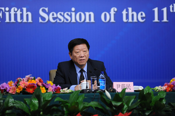 Yin Weimin, minister of human resources and social security, gives a press conference on China&apos;s employment situation and social security in Beijing, March 7, 2012.