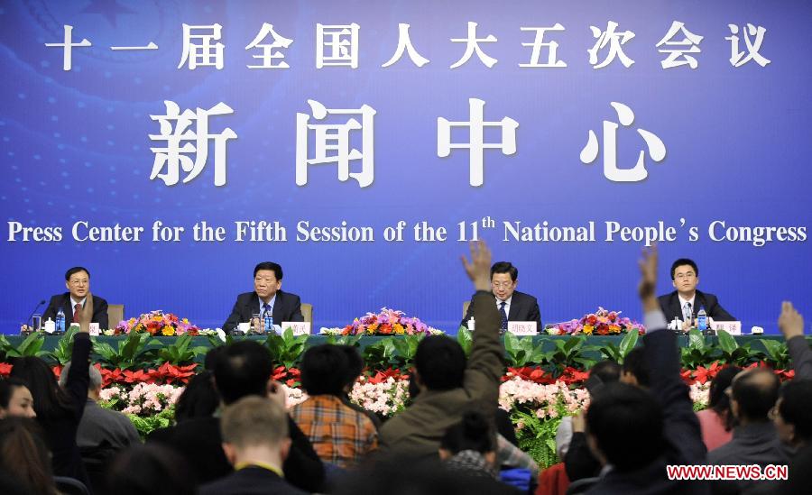 Minister of Human Resources and Social Security Yin Weimin (2nd L) and vice minister Hu Xiaoyi (2nd R) react during a news conference of the Fifth Session of the 11th National People&apos;s Congress (NPC) in Beijing, China, March 7, 2012.