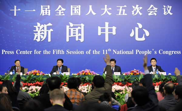 Minister of Human Resources and Social Security Yin Weimin (2nd L) and vice minister Hu Xiaoyi (2nd R) react during a news conference of the Fifth Session of the 11th National People's Congress (NPC) in Beijing, China, March 7, 2012.