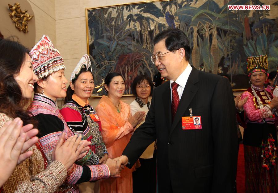 Chinese President Hu Jintao (R, front), who is also General Secretary of the Central Committee of the Communist Party of China (CPC) and Chairman of the Central Military Commission, visits deputies to the Fifth Session of the 11th National People's Congress (NPC) from southwest China's Yunnan Province and joins their panel discussion in Beijing, capital of China, March 7, 2012.