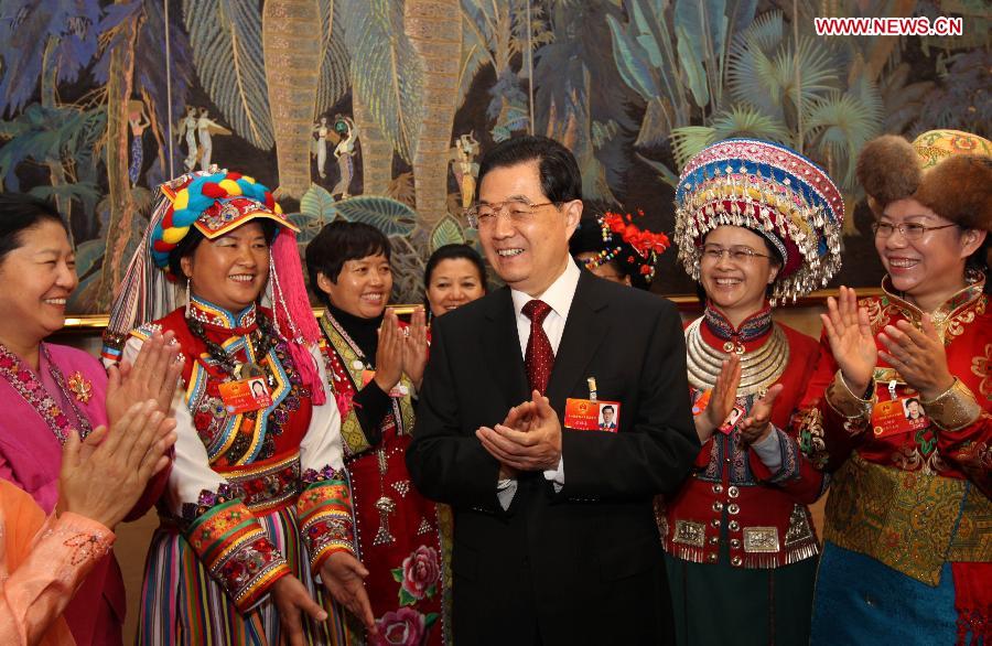 Chinese President Hu Jintao (C), who is also General Secretary of the Central Committee of the Communist Party of China (CPC) and Chairman of the Central Military Commission, visits deputies to the Fifth Session of the 11th National People's Congress (NPC) from southwest China's Yunnan Province and joins their panel discussion in Beijing, capital of China, March 7, 2012. 