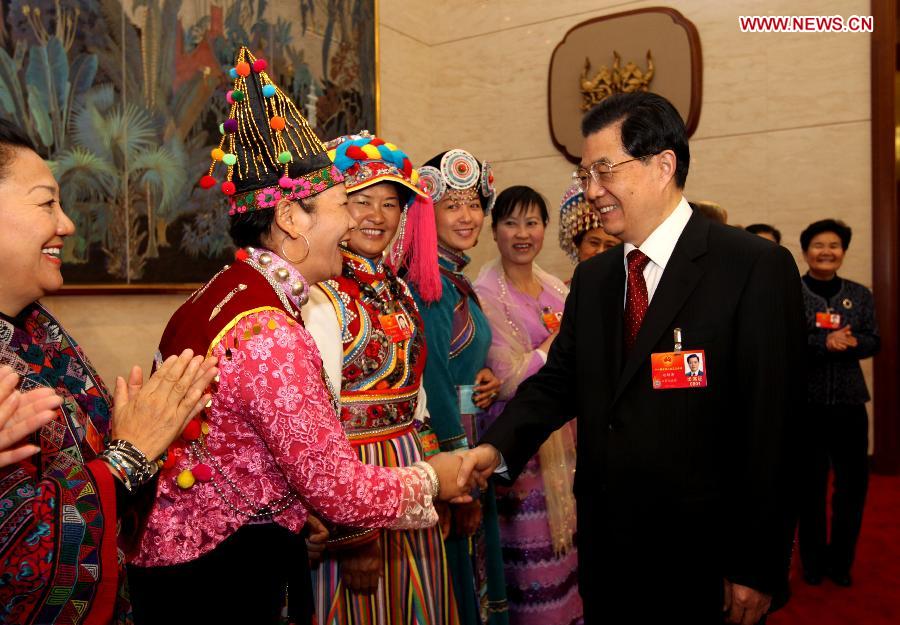 Chinese President Hu Jintao (R, front), who is also General Secretary of the Central Committee of the Communist Party of China (CPC) and Chairman of the Central Military Commission, visits deputies to the Fifth Session of the 11th National People's Congress (NPC) from southwest China's Yunnan Province and joins their panel discussion in Beijing, capital of China, March 7, 2012. 