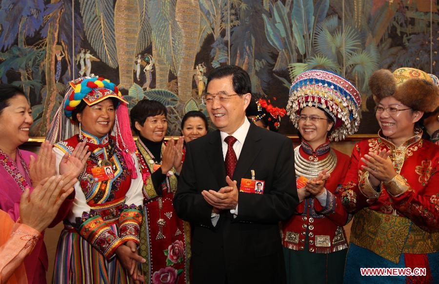 Chinese President Hu Jintao (C), who is also General Secretary of the Central Committee of the Communist Party of China (CPC) and Chairman of the Central Military Commission, visits deputies to the Fifth Session of the 11th National People's Congress (NPC) from southwest China's Yunnan Province and joins their panel discussion in Beijing, capital of China, March 7, 2012.