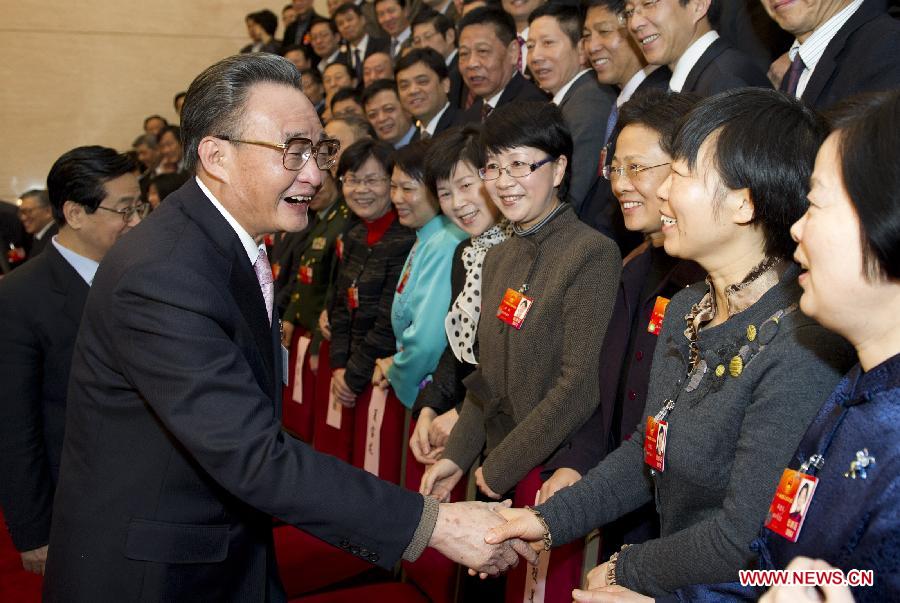 Wu Bangguo (L, front), member of the Standing Committee of the Political Bureau of the Communist Party of China (CPC) Central Committee and also chairman of the Standing Committee of the National People's Congress (NPC), visits deputies to the Fifth Session of the 11th NPC from east China's Zhejiang Province and joins their panel discussion in Beijing, capital of China, March 7, 2012.