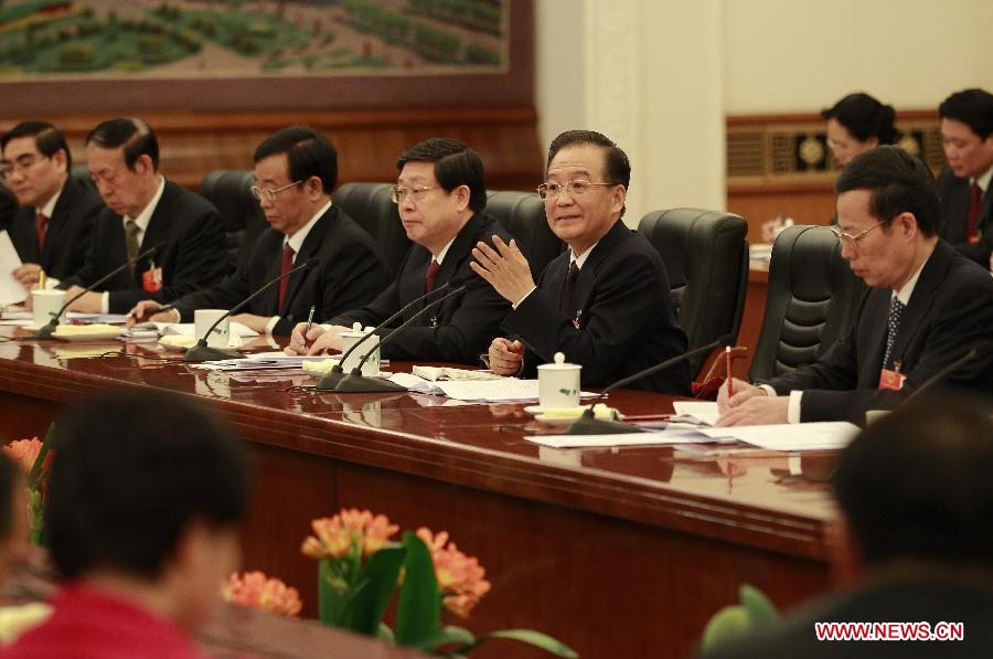 Chinese Premier Wen Jiabao (2nd R), who is also a memeber of the Standing Committee of the Political Bureau of the Communist Party of China (CPC) Central Committee, visits deputies to the Fifth Session of the 11th National People's Congress (NPC) from north China's Tianjin Municipality and joins their panel discussion in Beijing, capital of China, March 7, 2012.