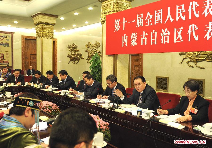 Li Changchun (2nd R), member of the Standing Committee of the Political Bureau of the Communist Party of China (CPC) Central Committee, visits deputies to the Fifth Session of the 11th National People's Congress (NPC) from north China's Inner Mongolia Autonomous Region and joins their panel discussion in Beijing, capital of China, March 7, 2012.