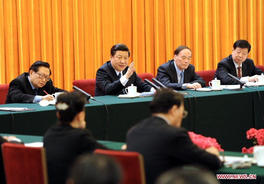 Chinese Vice President Xi Jinping (2nd L), who is also a member of the Standing Committee of the Political Bureau of the Communist Party of China (CPC) Central Committee, visits deputies to the Fifth Session of the 11th National People's Congress (NPC) from east China's Shandong Province and joins their panel discussion in Beijing, capital of China, March 7, 2012. 