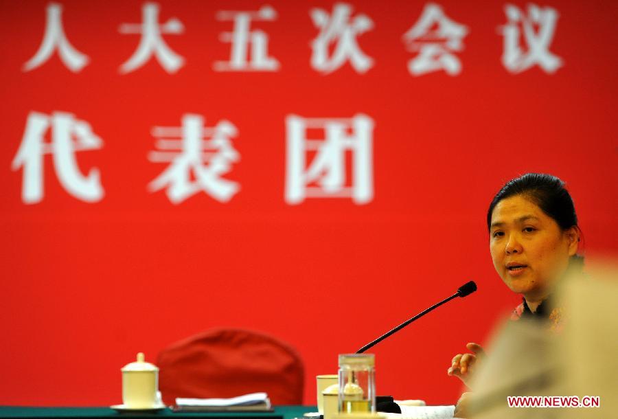 Geng Xuemei, a deputy to the Fifth Session of the 11th National People's Congress (NPC) from east China's Anhui Province, speaks during a panel discussion on supporting the development of small and micro businesses in Beijing, capital of China, March 6, 2012. 