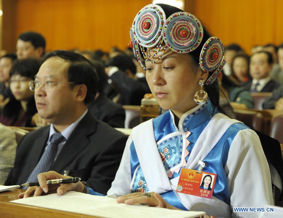 Yang Jinsong (R, front), a deputy to the Fifth Session of the 11th National People's Congress (NPC) from southwest China's Yunnan Province, attends the second plenary meeting of the NPC session at the Great Hall of the People in Beijing, capital of China, March 8, 2012.