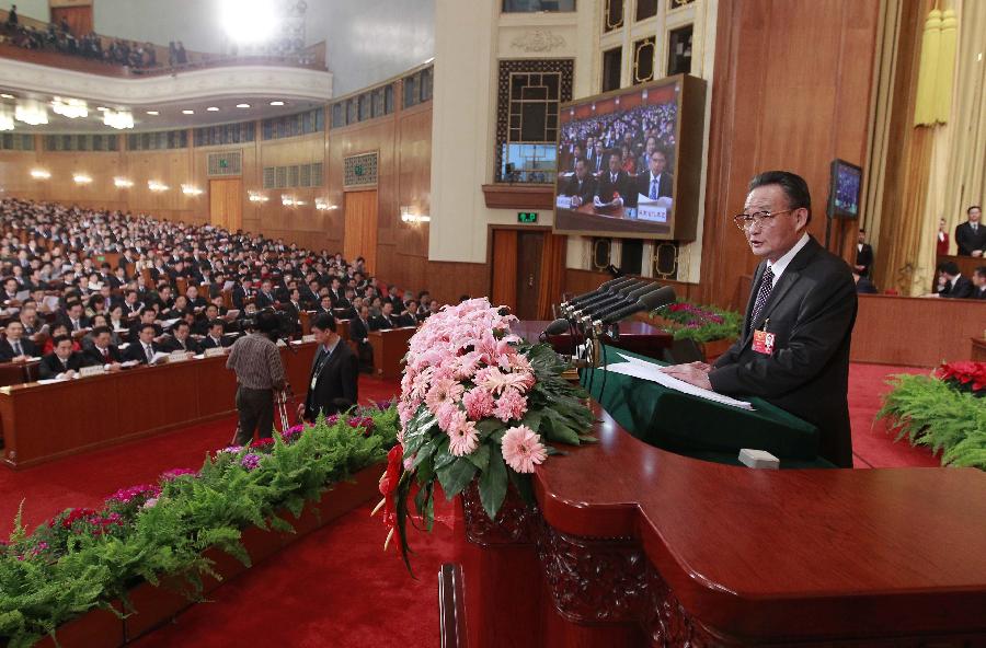 Wu Bangguo, chairman of the Standing Committee of the National People's Congress (NPC), delivers a work report of the Standing Committee of the NPC during the third plenary meeting of the Fifth Session of the 11th NPC at the Great Hall of the People in Beijing, capital of China, March 9, 2012. 