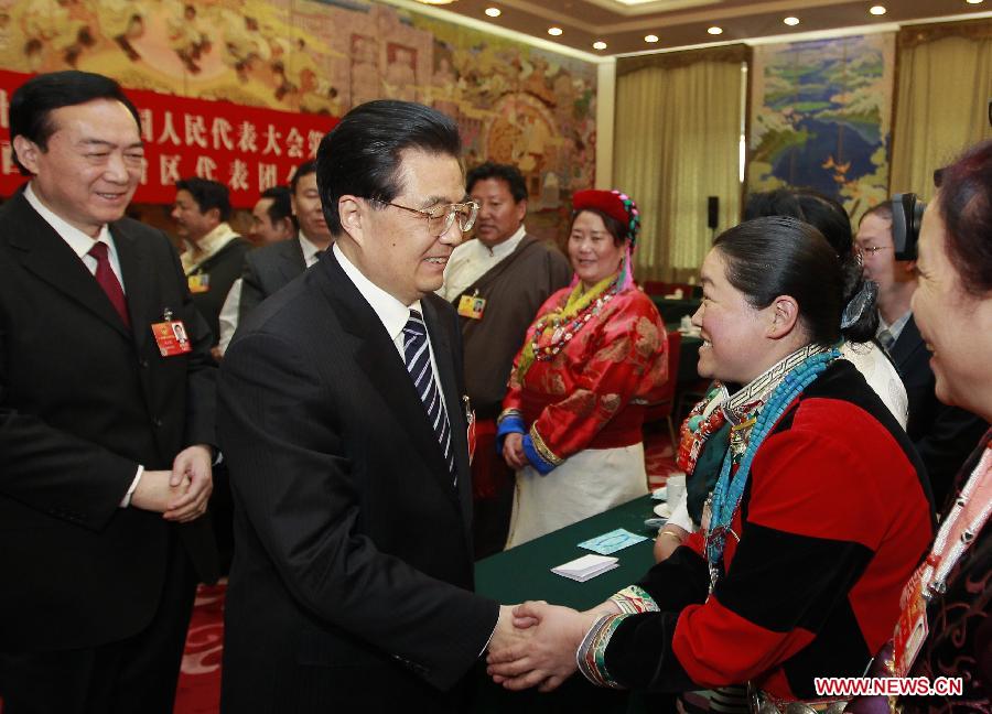 Chinese President Hu Jintao (2nd L, front), who is also General Secretary of the Central Committee of the Communist Party of China (CPC) and Chairman of the Central Military Commission, visits deputies to the Fifth Session of the 11th National People's Congress (NPC) from southwest China's Tibet Autonomous Region and joins their panel discussion in Beijing, capital of China, March 9, 2012. 