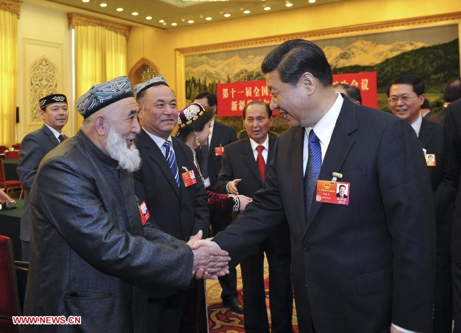 Chinese Vice President Xi Jinping (R, front), who is also a member of the Standing Committee of the Political Bureau of the Communist Party of China (CPC) Central Committee, visits deputies to the Fifth Session of the 11th National People&apos;s Congress (NPC) from northwest China&apos;s Xinjiang Uygur Autonomous Region and joins their panel discussion in Beijing, capital of China, March 9, 2012.