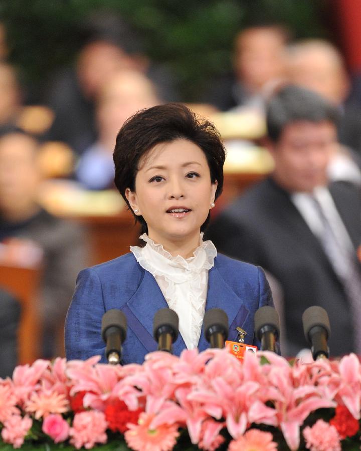 Yang Lan, a member of the 11th National Committee of the Chinese People's Political Consultative Conference (CPPCC), speaks during the fourth plenary meeting of the Fifth Session of the 11th CPPCC National Committee at the Great Hall of the People in Beijing, capital of China, March 11, 2012.