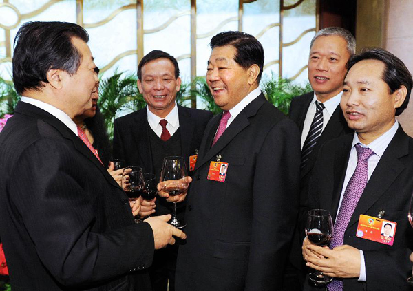 Jia Qinglin (3rd R), chairman of the National Committee of the Chinese People's Political Consultative Conference (CPPCC), attends a reception for members of the Fifth Session of the 11th CPPCC National Committee from the Hong Kong and Macao special administrative regions at the Diaoyutai State Guesthouse in Beijing, capital of China, March 11, 2012. 