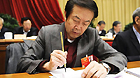 Artist Yuan Xikun takes notes with a writing brush at the Fifth Session of the 11th Chinese People's Political Consultative Conference (CPPCC) on March 9, 2012.