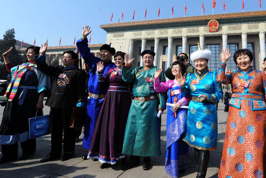 Members of the 11th National Committee of the Chinese People's Political Consultative Conference (CPPCC) pose for photos outside the Great Hall of the People after the closing meeting of the Fifth Session of the 11th CPPCC National Committee in Beijing, capital of China, March 13, 2012. 