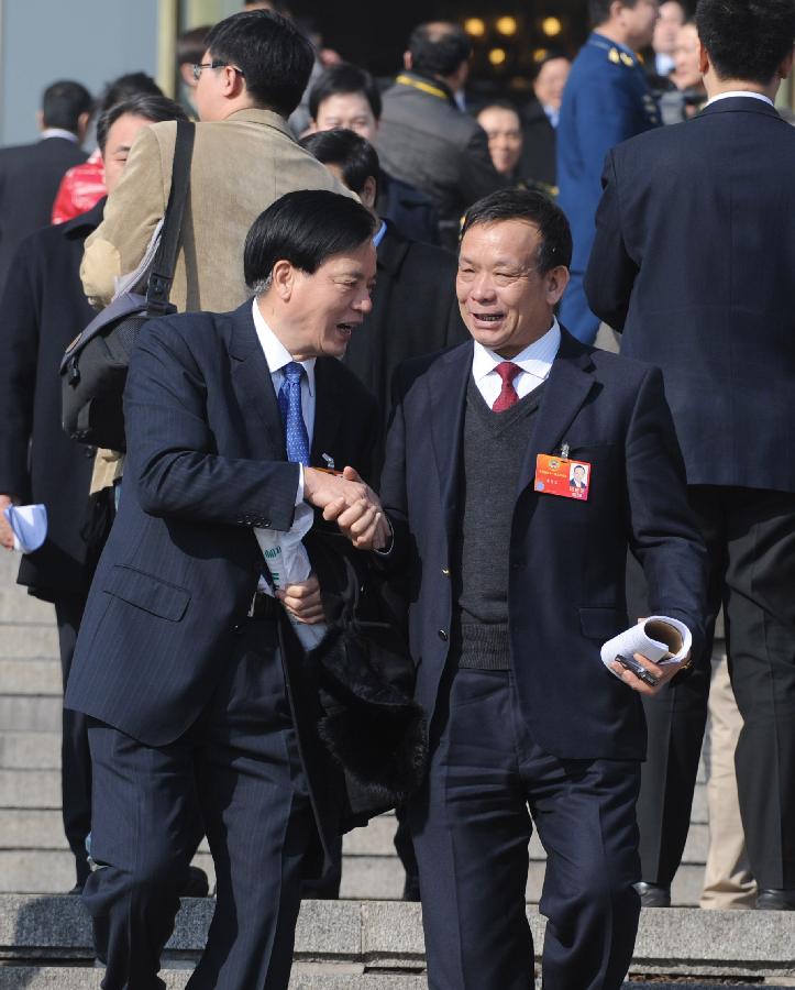 Members of the 11th National Committee of the Chinese People's Political Consultative Conference (CPPCC) shake hands to say goodbye outside the Great Hall of the People after the closing meeting of the Fifth Session of the 11th CPPCC National Committee in Beijing, capital of China, March 13, 2012.