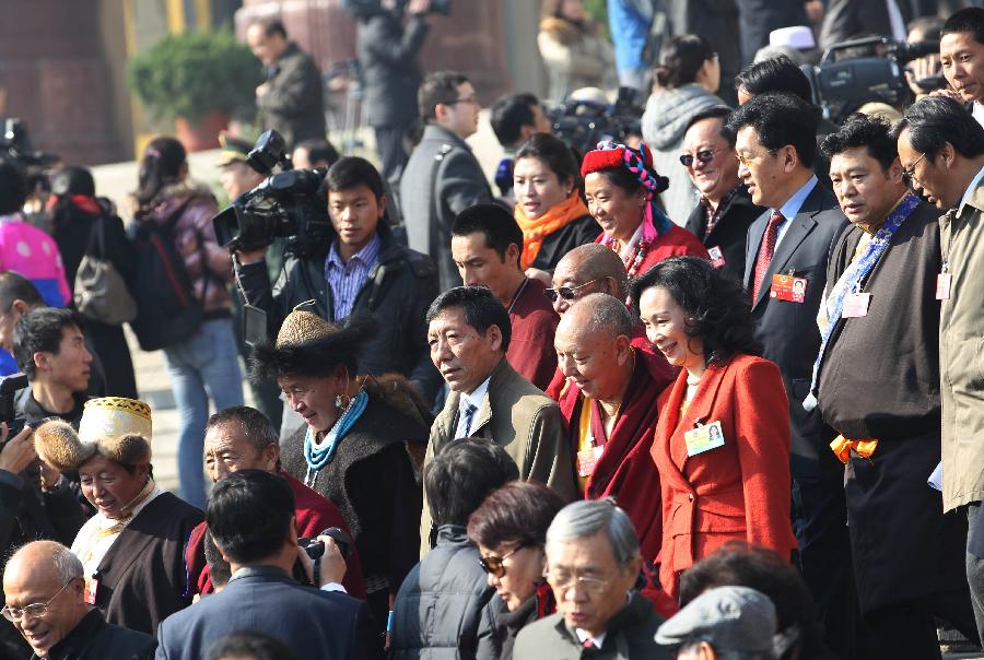 Members of the 11th National Committee of the Chinese People's Political Consultative Conference (CPPCC) leave the Great Hall of the People after the closing meeting of the Fifth Session of the 11th CPPCC National Committee in Beijing, capital of China, March 13, 2012.