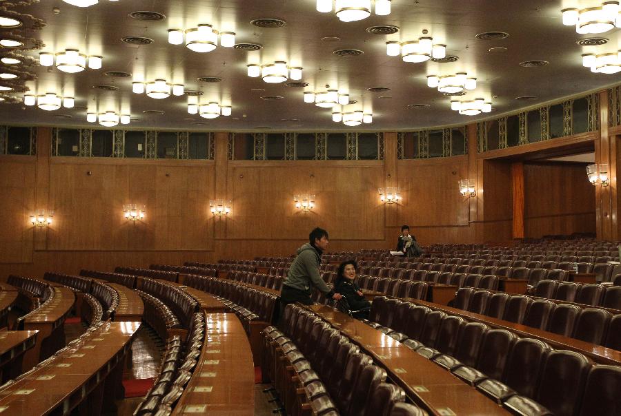 Wan Shanhong (in wheelchair), a member of the 11th National Committee of the Chinese People's Political Consultative Conference (CPPCC), leaves the conference hall in the Great Hall of the People after the closing meeting of the Fifth Session of the 11th CPPCC National Committee in Beijing, capital of China, March 13, 2012.