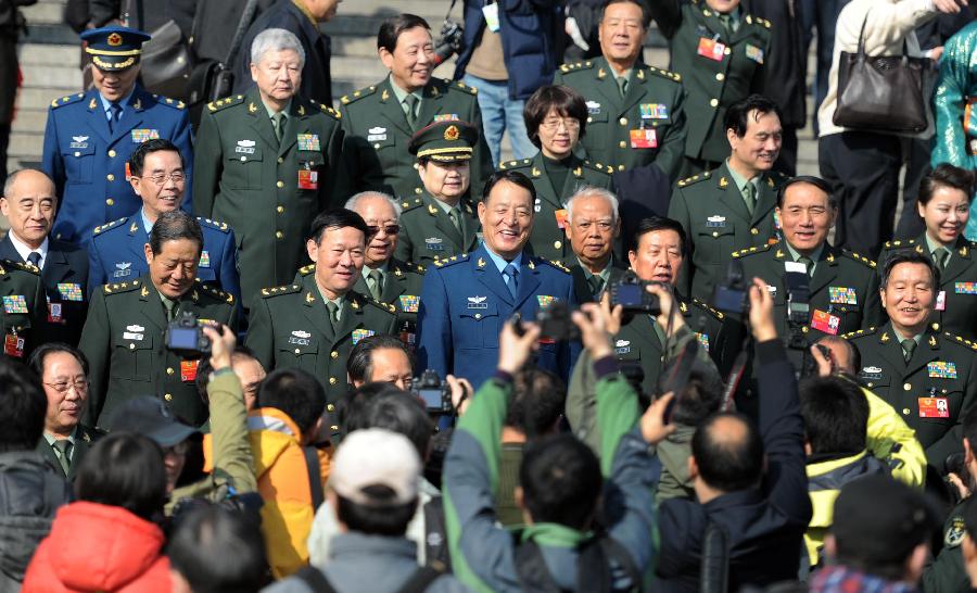 Members of the 11th National Committee of the Chinese People's Political Consultative Conference (CPPCC) leave the Great Hall of the People after the closing meeting of the Fifth Session of the 11th CPPCC National Committee in Beijing, capital of China, March 13, 2012.