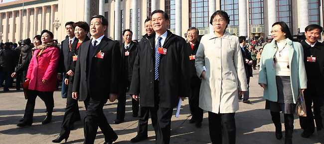Members of the 11th National Committee of the Chinese People's Political Consultative Conference (CPPCC) leave the Great Hall of the People after the closing meeting of the Fifth Session of the 11th CPPCC National Committee in Beijing, capital of China, March 13, 2012.