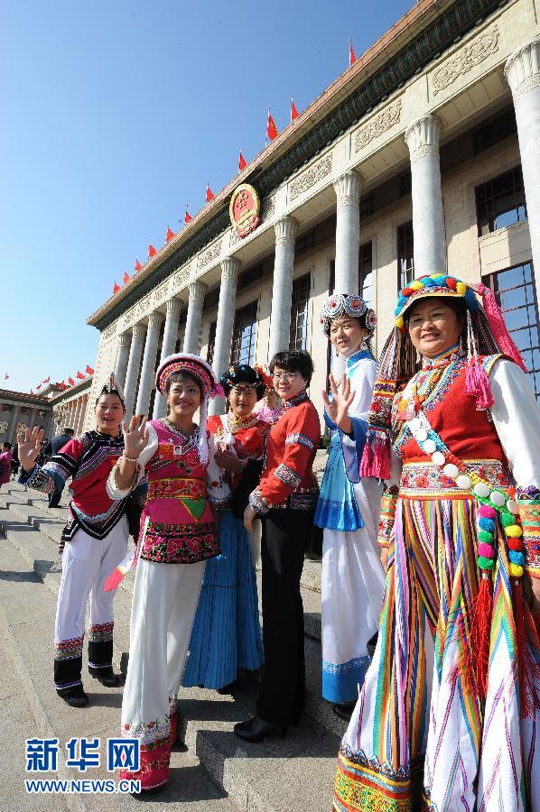 Deputies to the 11th National Committee of the National People’s Congress (NPC) pose for photos outside the Great Hall of the People prior to the closing meeting of the Fifth Session of the 11th NPC National Committee in Beijing, March 14, 2012. 