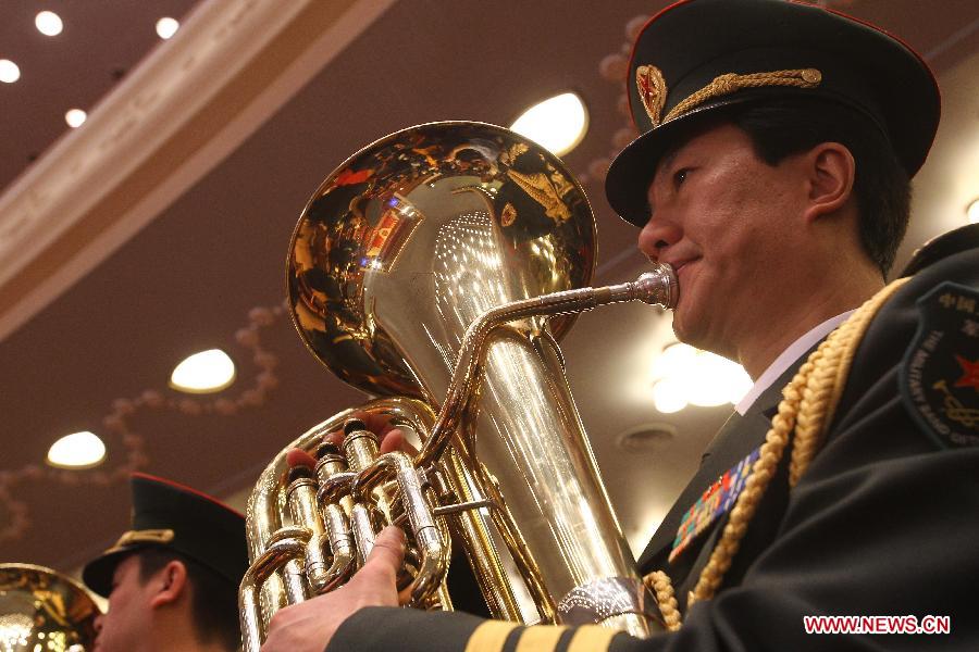 The military band of Chinese People's Liberation Army plays during the closing meeting of the Fifth Session of the 11th National People's Congress (NPC) at the Great Hall of the People in Beijing, capital of China, March 14, 2012.