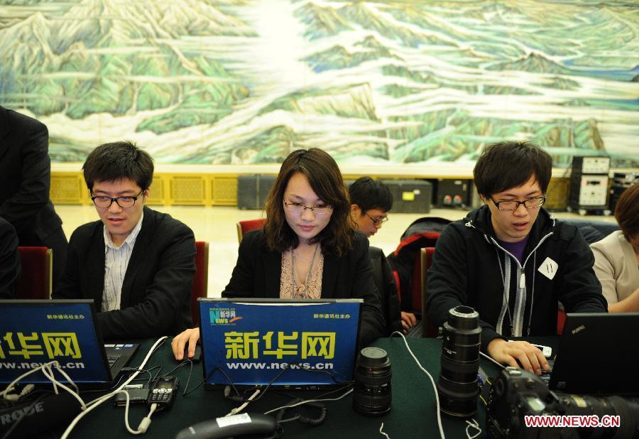 Journalists prepare for reporting a press conference which Chinese Premier Wen Jiabao will attend after the closing meeting of the Fifth Session of the 11th National People's Congress (NPC) at the Great Hall of the People in Beijing, capital of China, March 14, 2012.