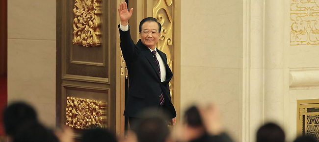 Chinese Premier Wen Jiabao greets the journalists when arriving at a press conference after the closing meeting of the Fifth Session of the 11th National People's Congress (NPC) at the Great Hall of the People in Beijing, capital of China, March 14, 2012.
