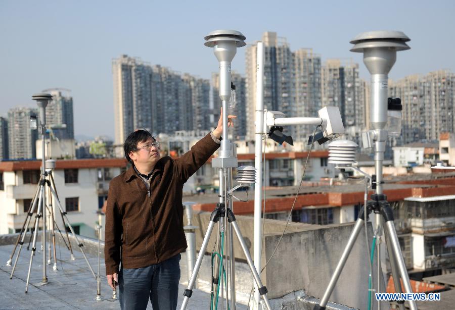 Observer Hong Shengmao checks a PM2.5 monitor at the Hangzhou Environmental Monitoring Center in Hangzhou, capital of east China&apos;s Zhejiang Province on March 25, 2012.