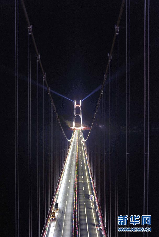 Workers complete final lighting tests in readiness for the opening of the Aizhai Extra--large Suspension Bridge in Aizhai Town of Jishou City, central China&apos;s Hunan Province, on Mar. 31, 2012.