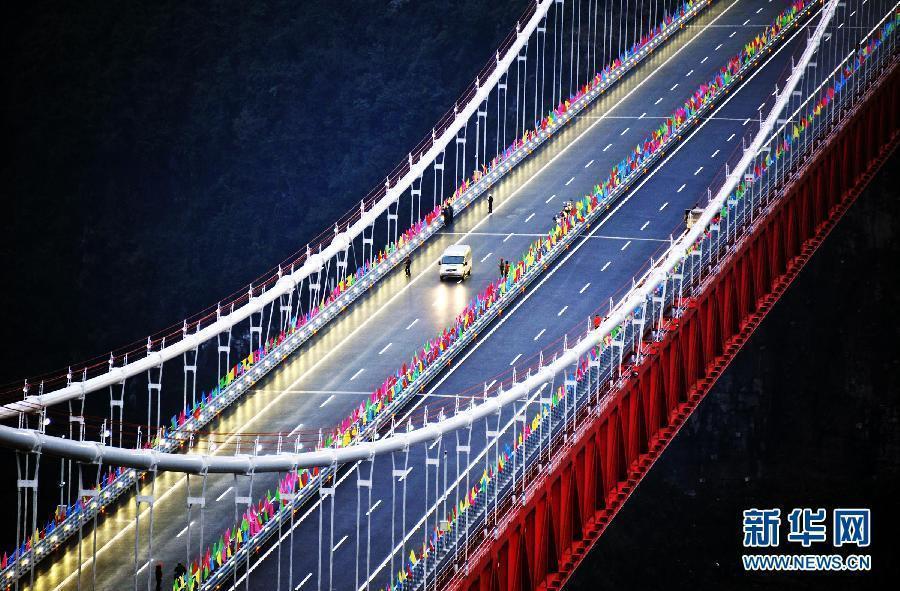 Workers complete final lighting tests in readiness for the opening of the Aizhai Extra--large Suspension Bridge in Aizhai Town of Jishou City, central China&apos;s Hunan Province, on Mar. 31, 2012.