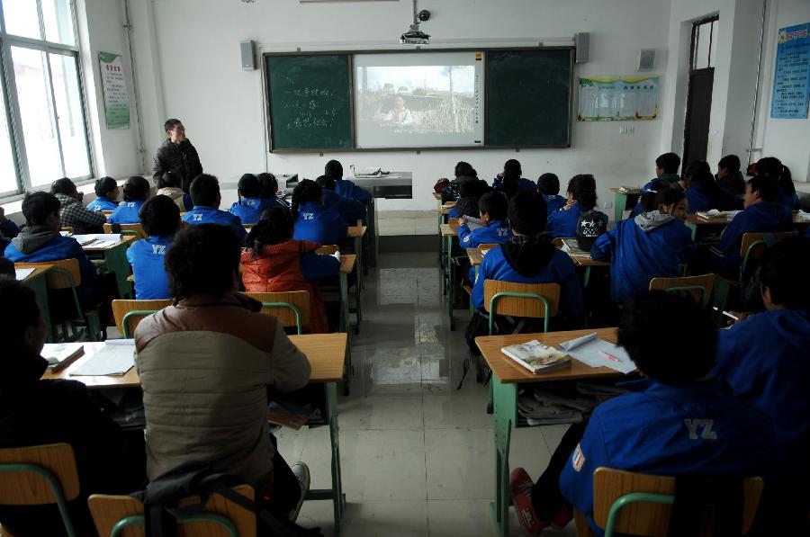 Students watch movie in the classroom of the 3rd Minzu High School in Yushu Tibetan Autonomous Prefecture, northwest China's Qinghai Province, on April 13, 2012.