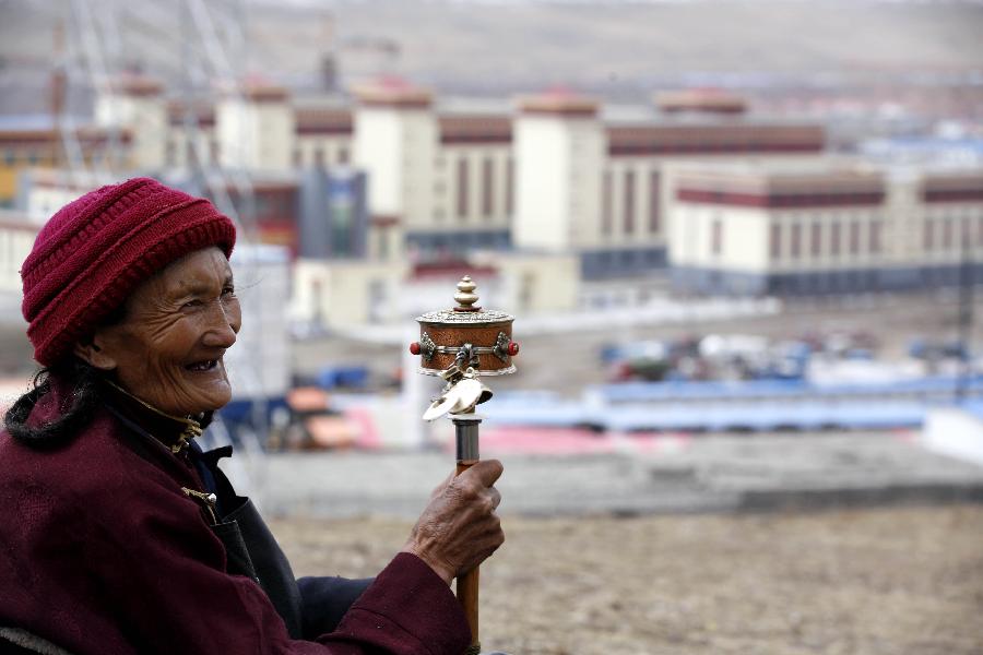 An old woman chants sutras in Yushu Tibetan Autonomous Prefecture, northwest China's Qinghai Province, on April 12, 2012. 