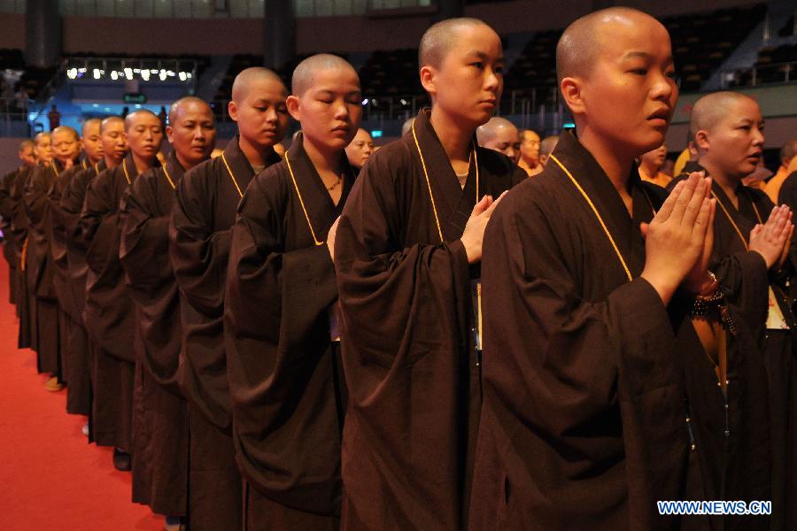 Monks attend the concluding ceremony of the Grand Blessing Ceremony for Worshipping Buddha&apos;s Parietal-Bone Relic in Macao, south China, May 4, 2012. 
