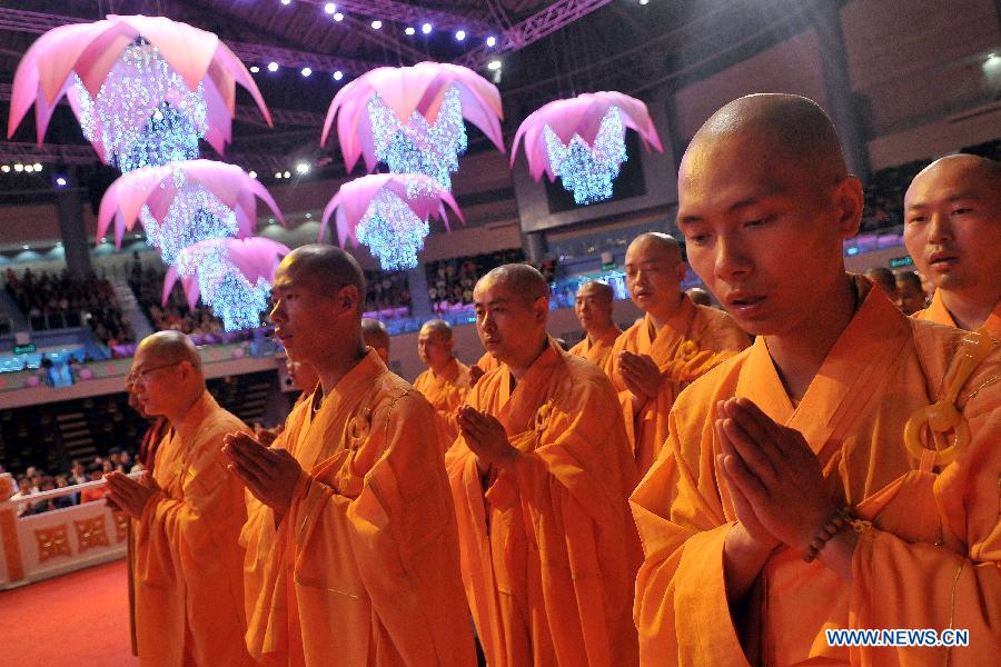 Monks attend the concluding ceremony of the Grand Blessing Ceremony for Worshipping Buddha&apos;s Parietal-Bone Relic in Macao, south China, May 4, 2012.