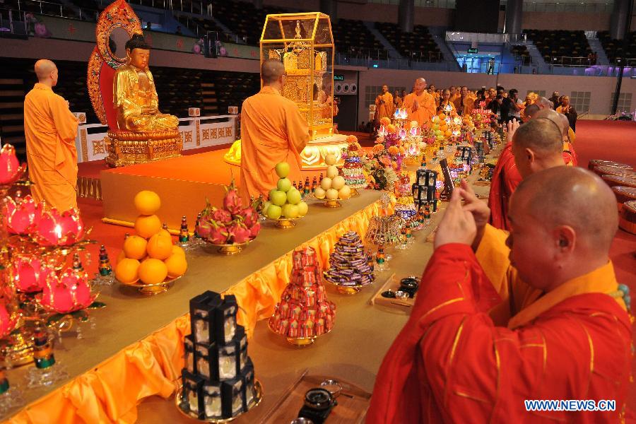 Monks attend the concluding ceremony of the Grand Blessing Ceremony for Worshipping Buddha&apos;s Parietal-Bone Relic in Macao, south China, May 4, 2012.