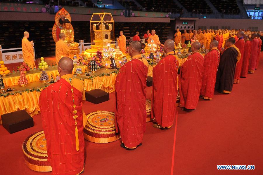 Monks attend the concluding ceremony of the Grand Blessing Ceremony for Worshipping Buddha&apos;s Parietal-Bone Relic in Macao, south China, May 4, 2012.