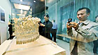 A tourist takes photos of a silver accessory during the Guizhou ethnic minority costume exhibition in Harbin, capital of northeast China's Heilongjiang Province, May 17, 2012.
