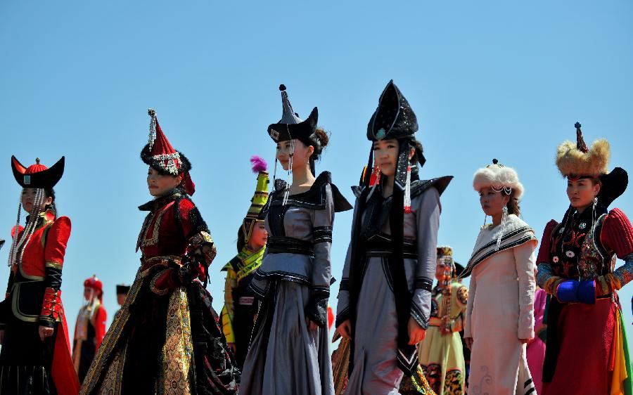 People perform during the opening of a Nadam fair in West Ujimqin Banner, north China's Inner Mongolia Autonomous Region, July 16, 2012.