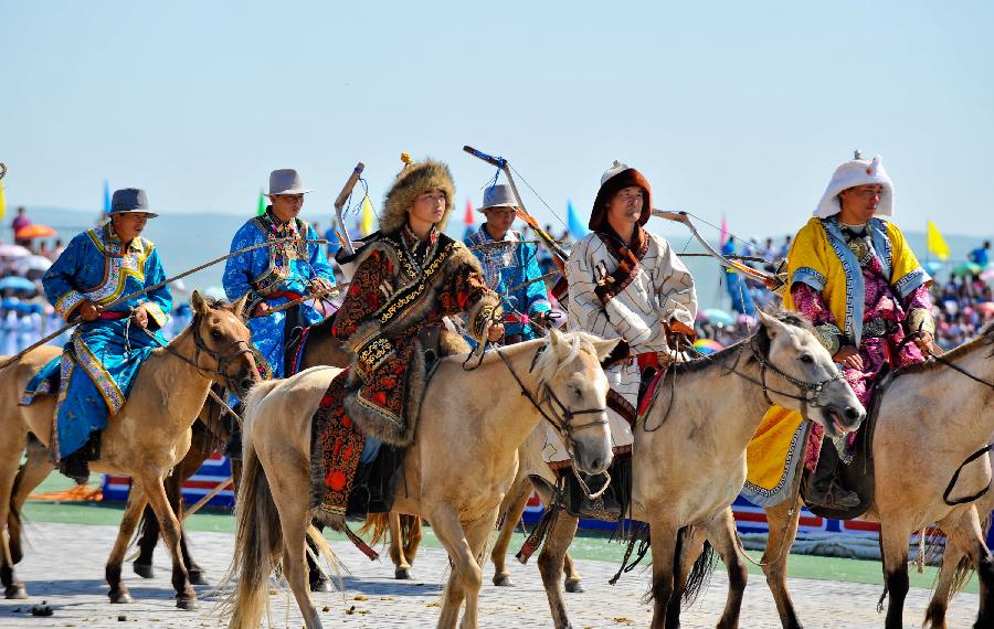 People perform during the opening of a Nadam fair in West Ujimqin Banner, north China's Inner Mongolia Autonomous Region, July 16, 2012.